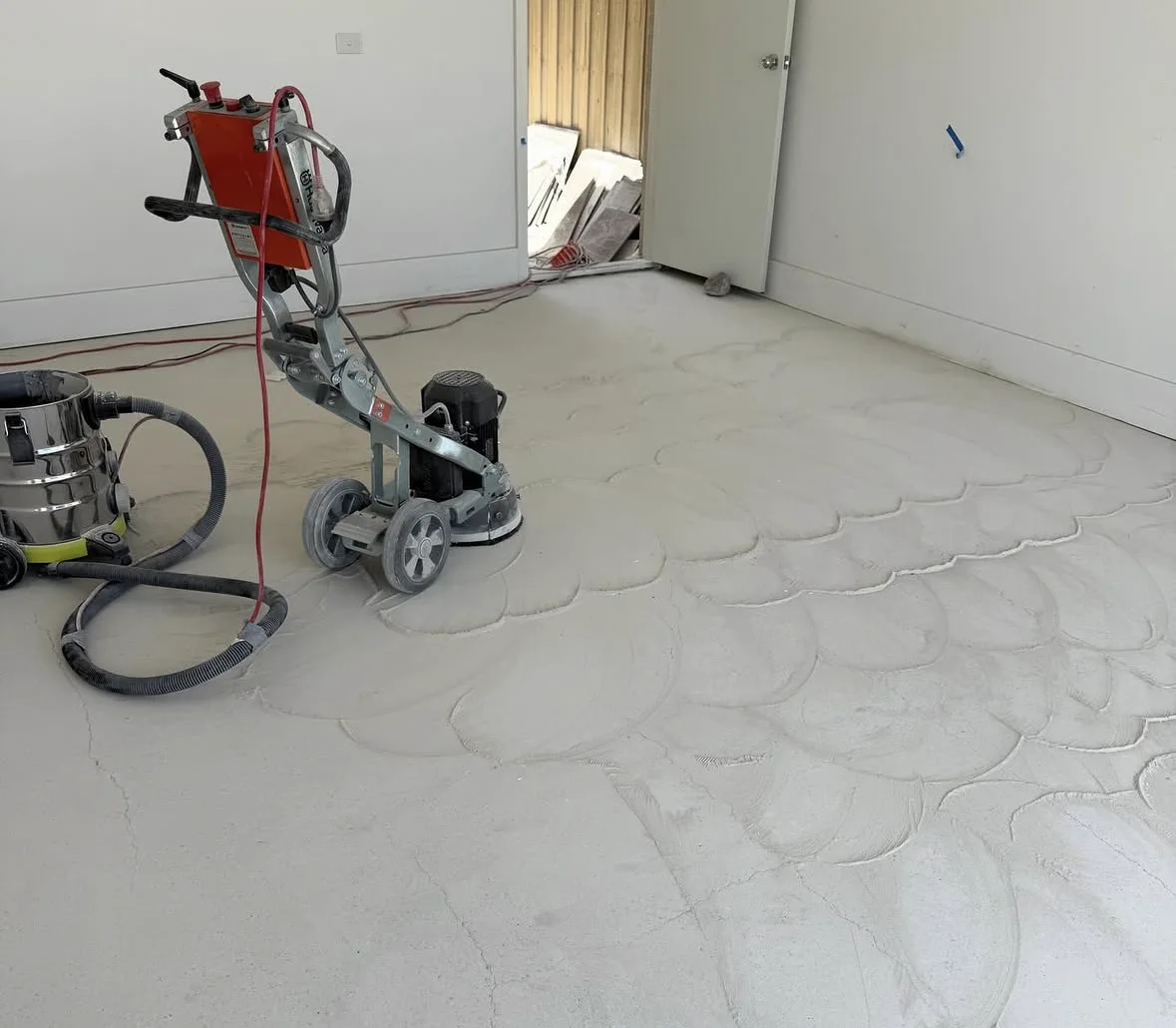 Floor preparation in progress with a concrete grinding machine